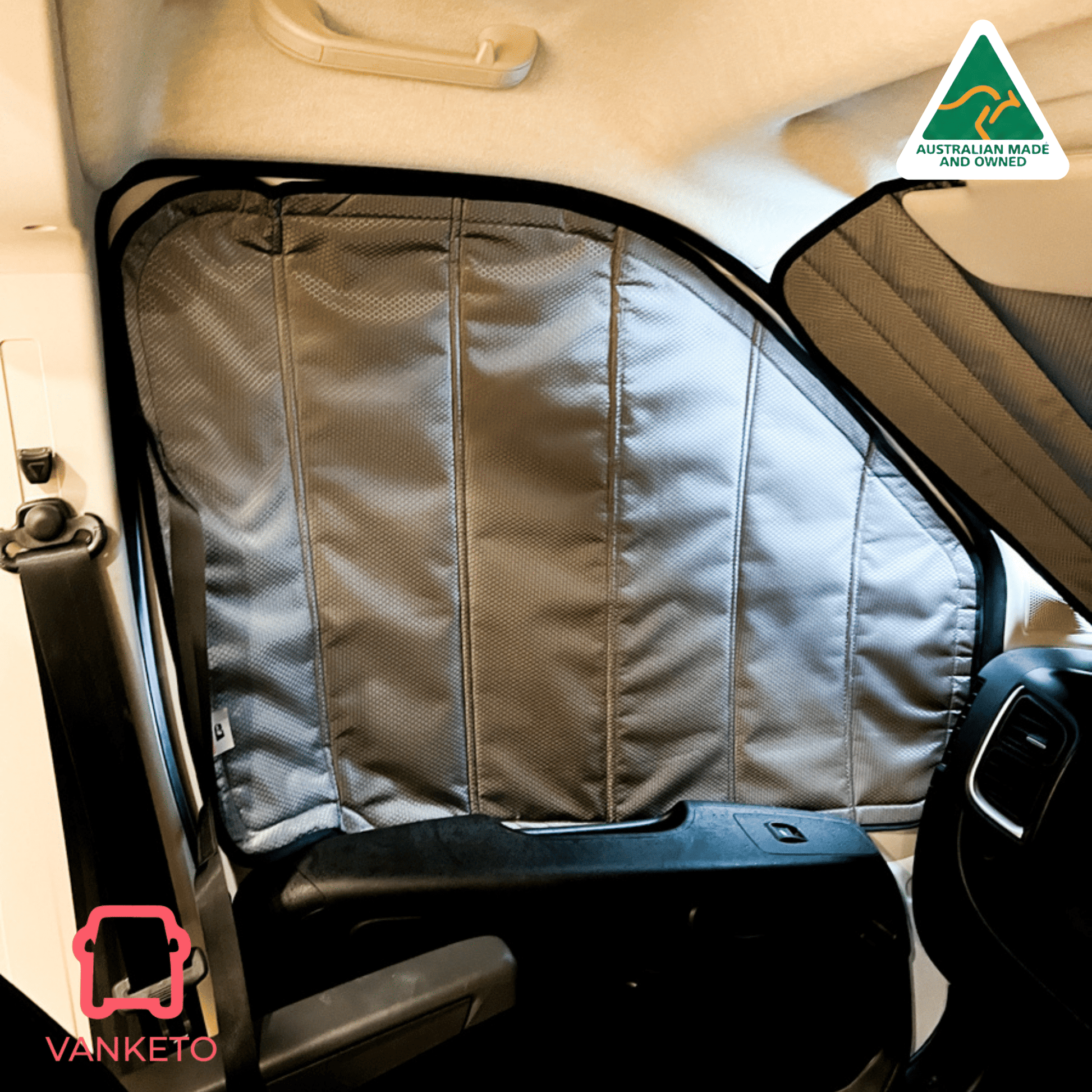 A gray Vanketo vehicle window shade installed on a car door, shown in a real vehicle interior with the steering wheel and dashboard visible. A Vanketo logo appears in the bottom-left corner, and an Australian Made and Vanketo badge appears in the top-right.