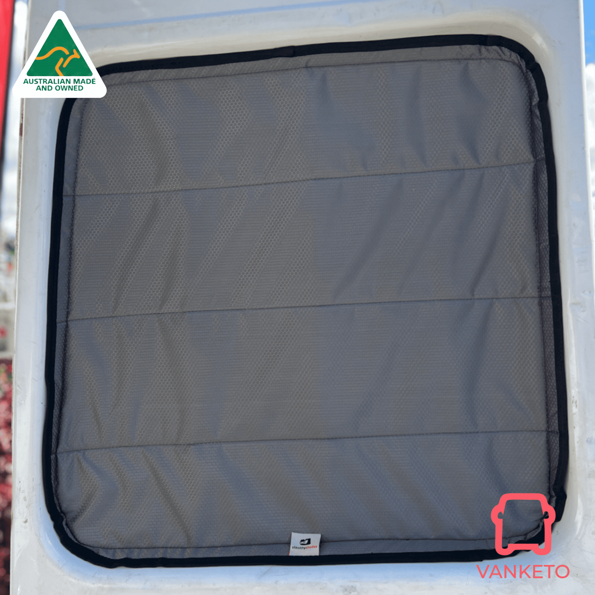 A gray padded window cover with black trim installed inside a white vehicle window. A small Vanketo logo tag is visible near the bottom, and a Vanketo logo watermark appears in the lower right corner.