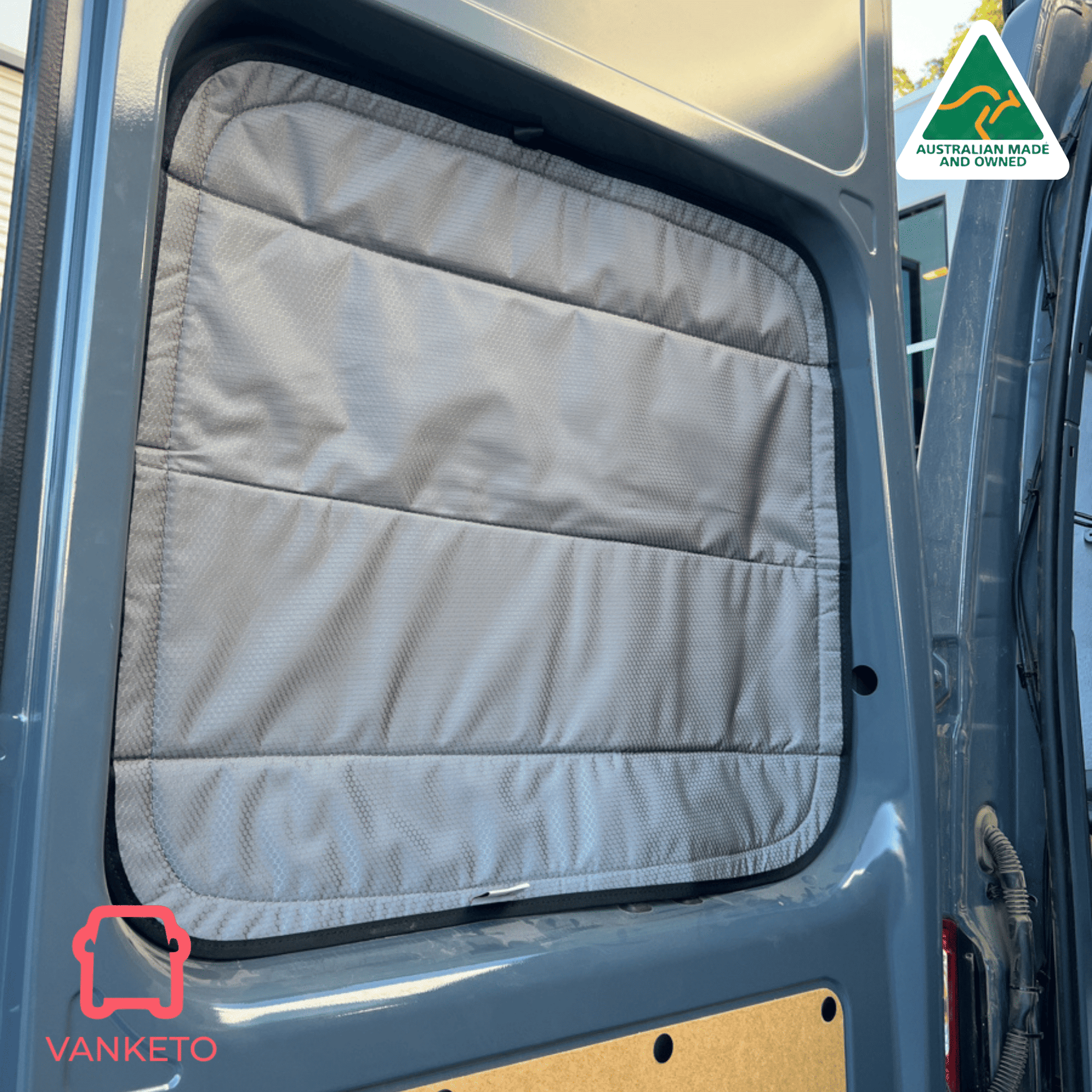 A light gray padded fabric window shade installed on a vehicle side window, shown in a real vehicle environment with a Vanketo logo in the corner and an Australian Made and Vanketo badge.