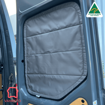 A gray padded van door window shade installed inside a vehicle door, shown in use on a dark blue-gray van with an Australian Made and Vanketo logo overlay.