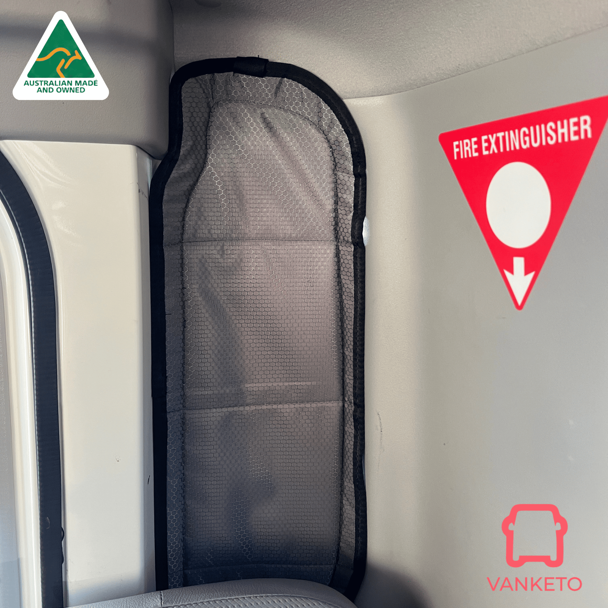 A gray mesh vehicle window shade with a black fabric border, shown installed inside a cab next to a window. The image includes a Vanketo logo in the bottom right corner and an Australian Made and Vefined badge in the top left.